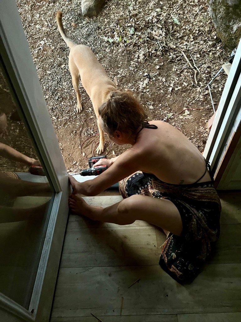Joy and Floki installing Joy's tiny cabin door